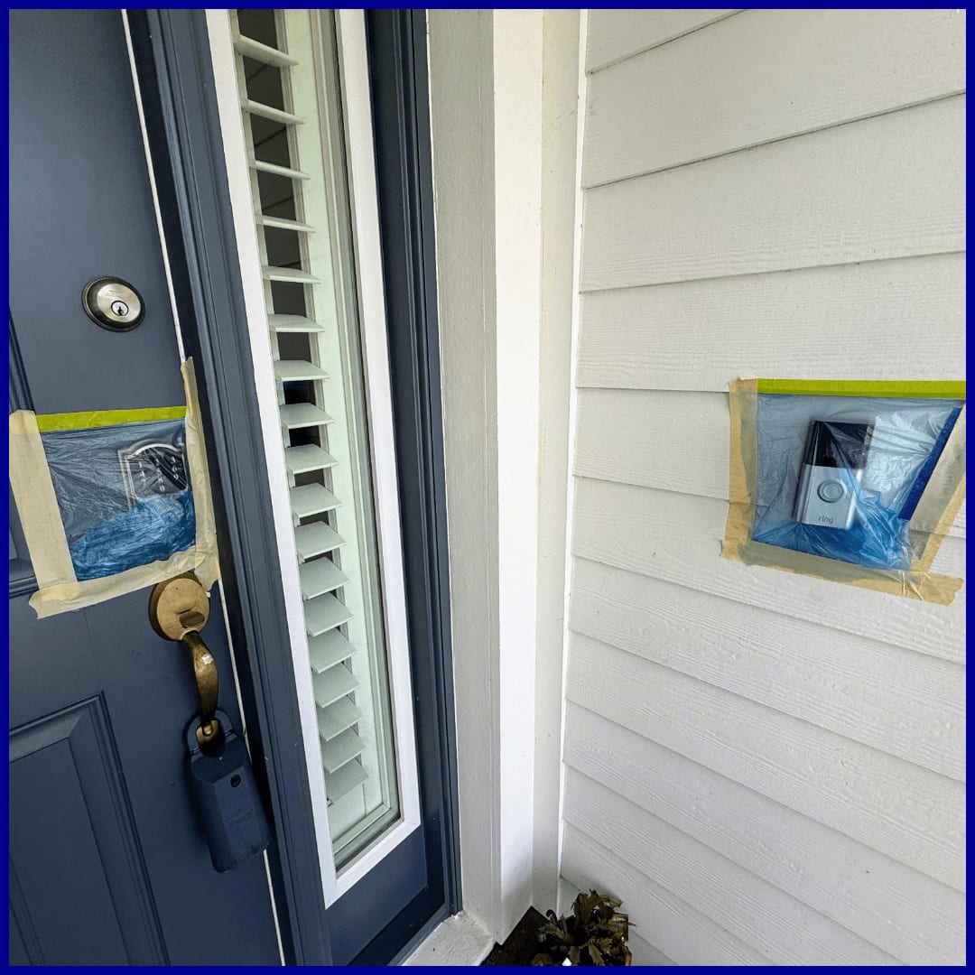 Rinsing a freshly soft-washed house exterior